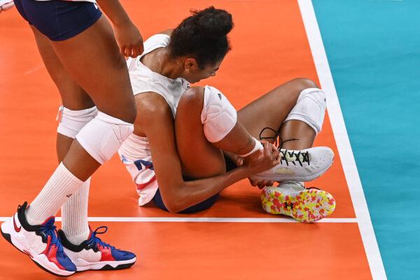 USA's Jordan Thompson reacts after getting injured in the women's preliminary round pool B volleyball match between USA and Russia during the Tokyo 2020 Olympic Games at Ariake Arena in Tokyo, Japan, on July 31, 2021. (Jung Yeon-Je/AFP via Getty Images)