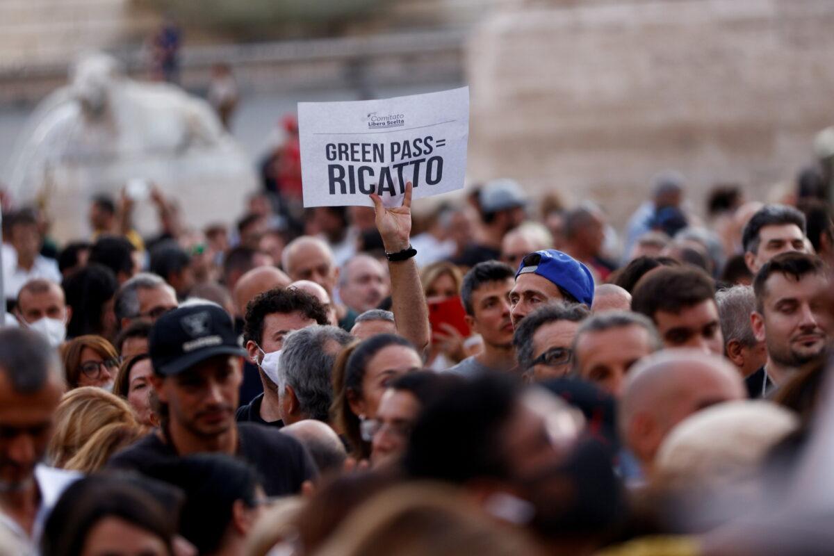 A banning reads "Green Pass = Blackmail" is seen at a demonstration against the Green Pass plan (health pass) in Rome on July 28, 2021. (Guglielmo Mangiapane/Reuters)
