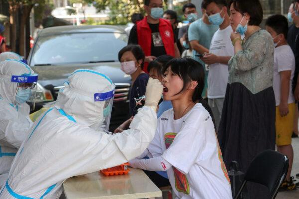 A woman being swabbed for a COVID-19 test in Zhengzhou, Central China's Henan Province on July 31, 2021. (-/AFP via Getty Images)