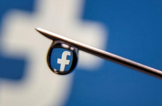 The Facebook logo is reflected in a drop on a syringe needle in this illustration photo taken March 16, 2021. (Dado Ruvic/Illustration/Reuters)