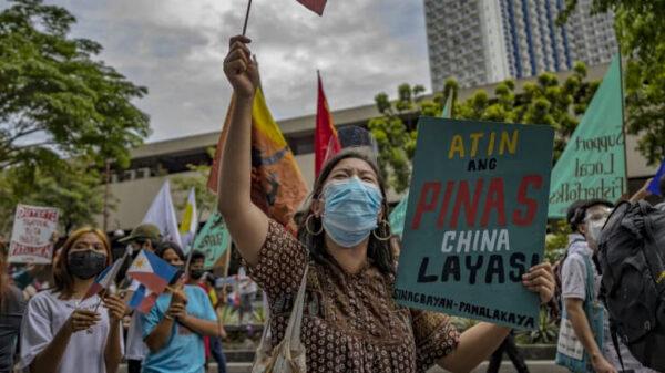 Filipinos march as they mark Independence Day with a protest against continued Chinese intrusions in Philippine waters outside the Chinese Embassy in Makati, Metro Manila, Philippines, on June 12, 2021. (Ezra Acayan/Getty Images)