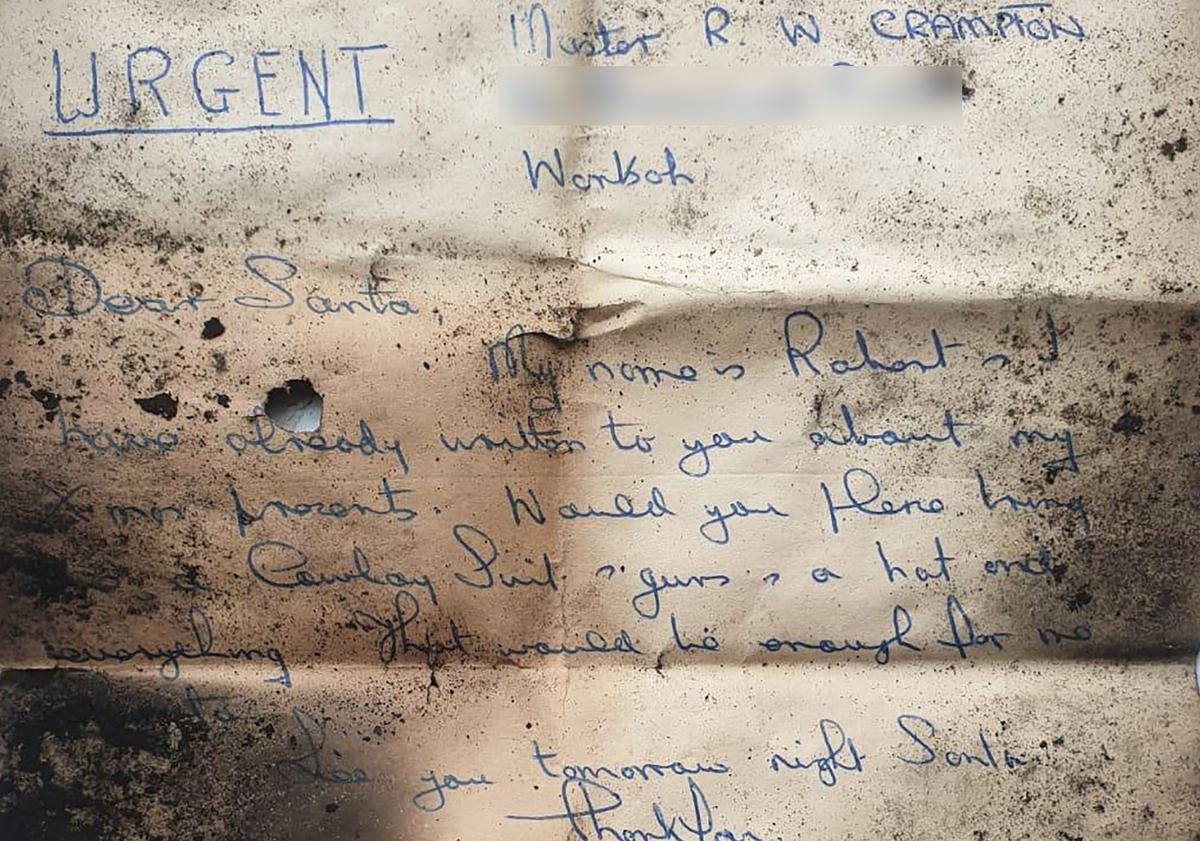 A child's letter addressed to Santa has been found perfectly folded in a chimney after being stuck there for more than 60 years. (SWNS)