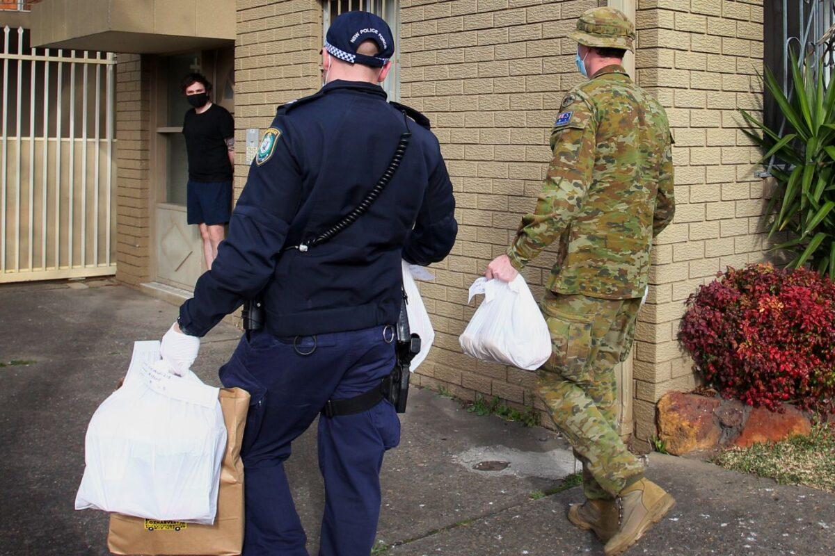 Australian Defence Force personnel and NSW police deliver food packages to people in lockdown in the Fairfield district in Sydney on Aug. 2, 2021. (Photo by Lisa Maree Williams/Getty Images)