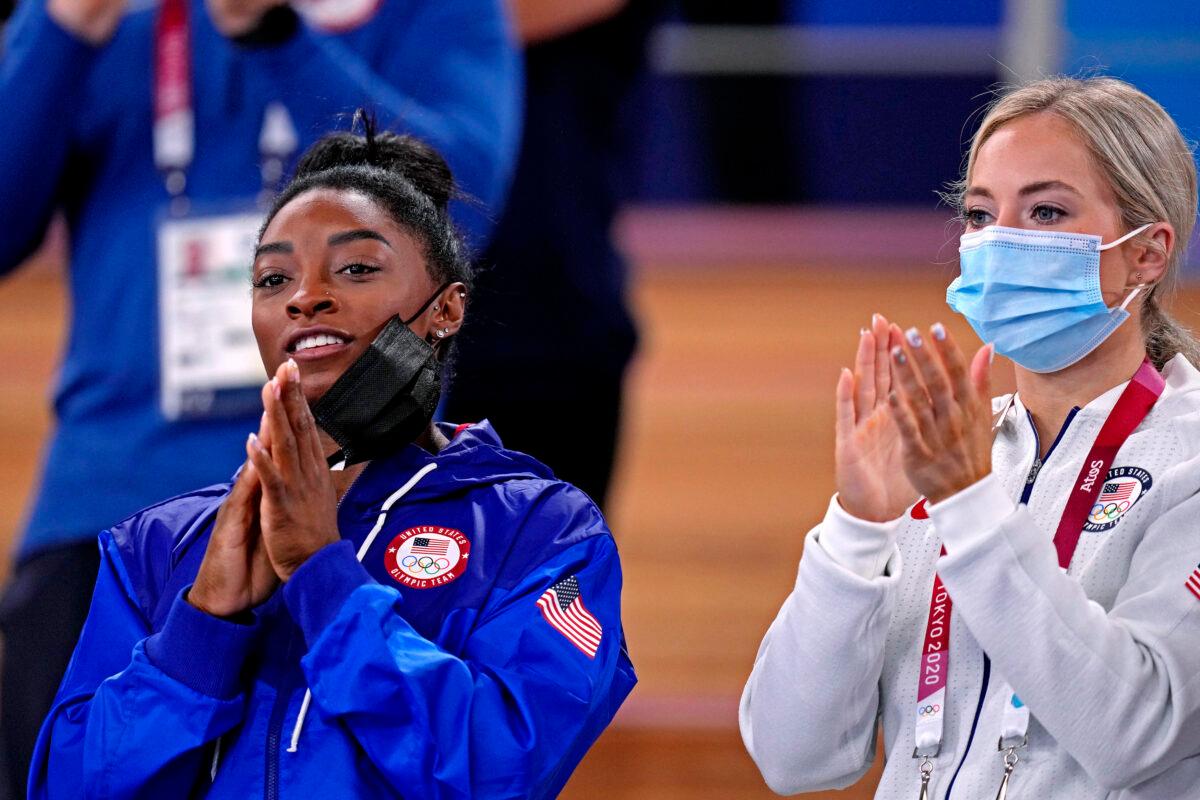 Simone Biles (L) and Mykalya Skinner (R) cheer during the Tokyo 2020 Olympic Summer Games at Ariake Gymnastics Centre on Aug. 2, 2021. (Danielle Parhizkaran/USA TODAY Sports via Reuters)