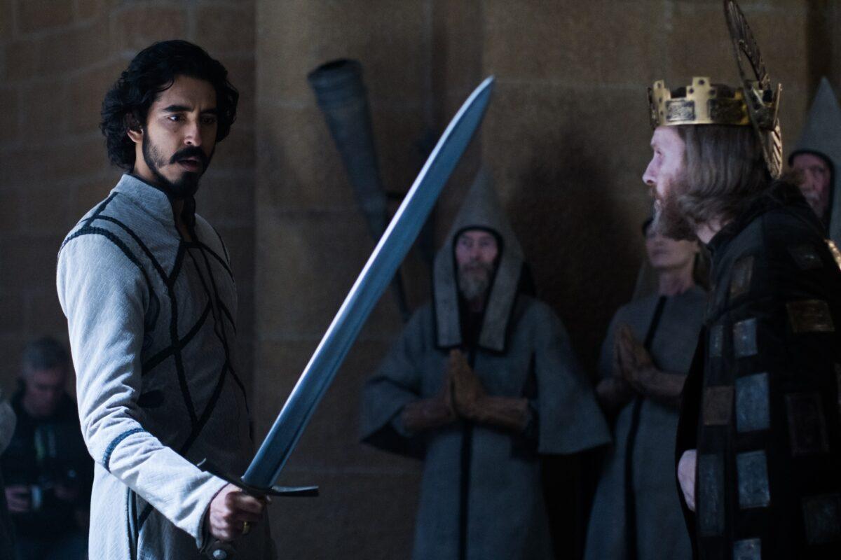 Gawain (Dev Patel, front L) and King Arthur (Sean Harris) in "The Green Knight." (A24)