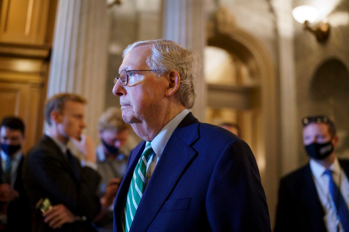 Senate Minority Leader Mitch McConnell (R-Ky.) walks past the chamber as the Senate advances to formally begin debate on a roughly $1 trillion infrastructure plan, a process that could take several days, at the Capitol in Washington on July 30, 2021. (J. Scott Applewhite/AP Photo)