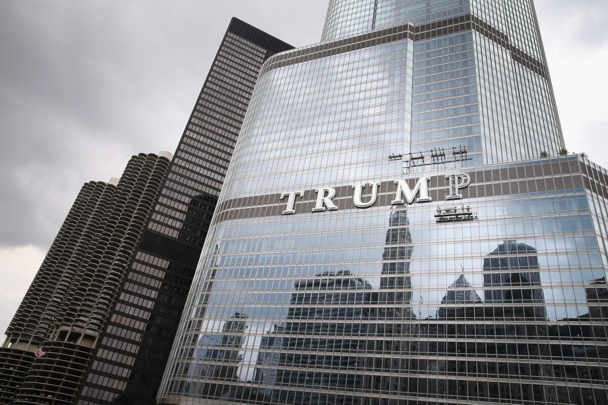 Workers install the final letter for a giant TRUMP sign on the outside of the Trump Tower in Chicago, Ill. on June 12, 2014. (Scott Olson/Getty Images)