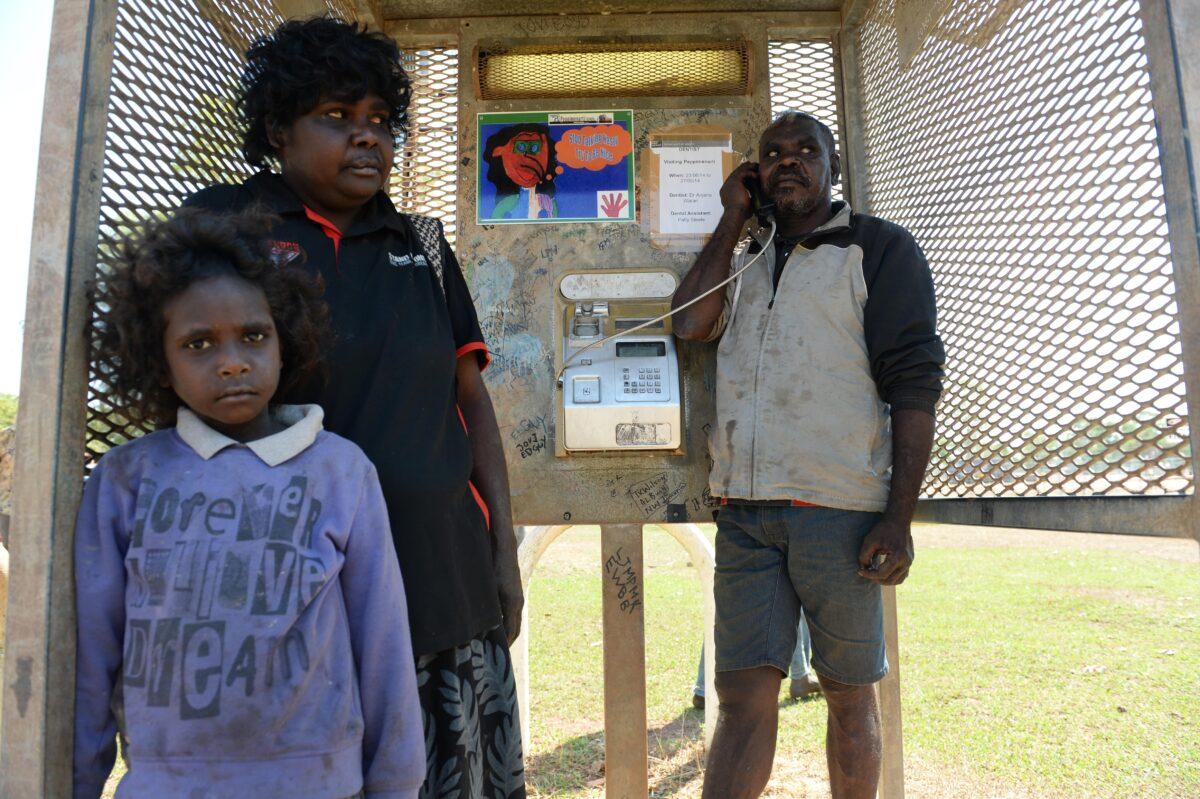 A man uses a payphone in the aboriginal community of Peppimenarti, south-west of Darwin, Australia, on July 4, 2014. (AAP Image/Dan Peled)