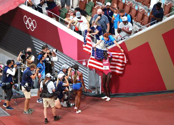 Athing Mu of the United States celebrates with national flag after winning gold in Tokyo on Aug. 3, 2021. (Fabrizio Bensch/Reuters)
