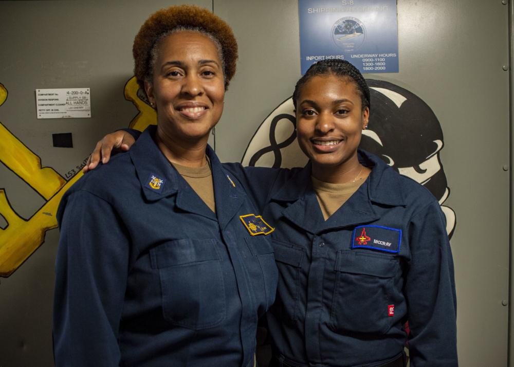 Master Chief Logistics Specialist Tanya McCray (L) with her daughter, Logistics Specialist Seaman Racquel McCray. (Courtesy of Gary Prill via <a href="https://www.dvidshub.net/news/401323/big-boots-fill">DVIDSHUB</a>)