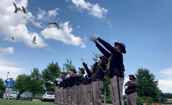 Sheriff's deputies release white doves for the young victims of a fatal car crash outside a church where the public memorial service was held, in Auburn, Ala., on July 15, 2021. (Kim Chandler/File/AP Photo)