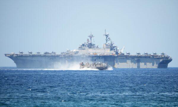 A U.S. Navy hovercraft speeds past the USS Wasp (LHD-1), a multipurpose amphibious assault ship, during joint U.S.-Philippines military exercises in the South China Sea in 2019. (Ted Aljibe/AFP via Getty Images)