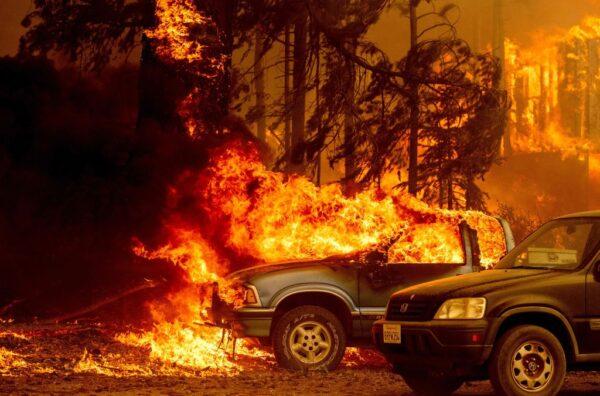Vehicles and a home are engulfed in flames as the Dixie fire rages on in Greenville, Calif., on Aug. 5, 2021. (Josh Edelson/AFP via Getty Images)