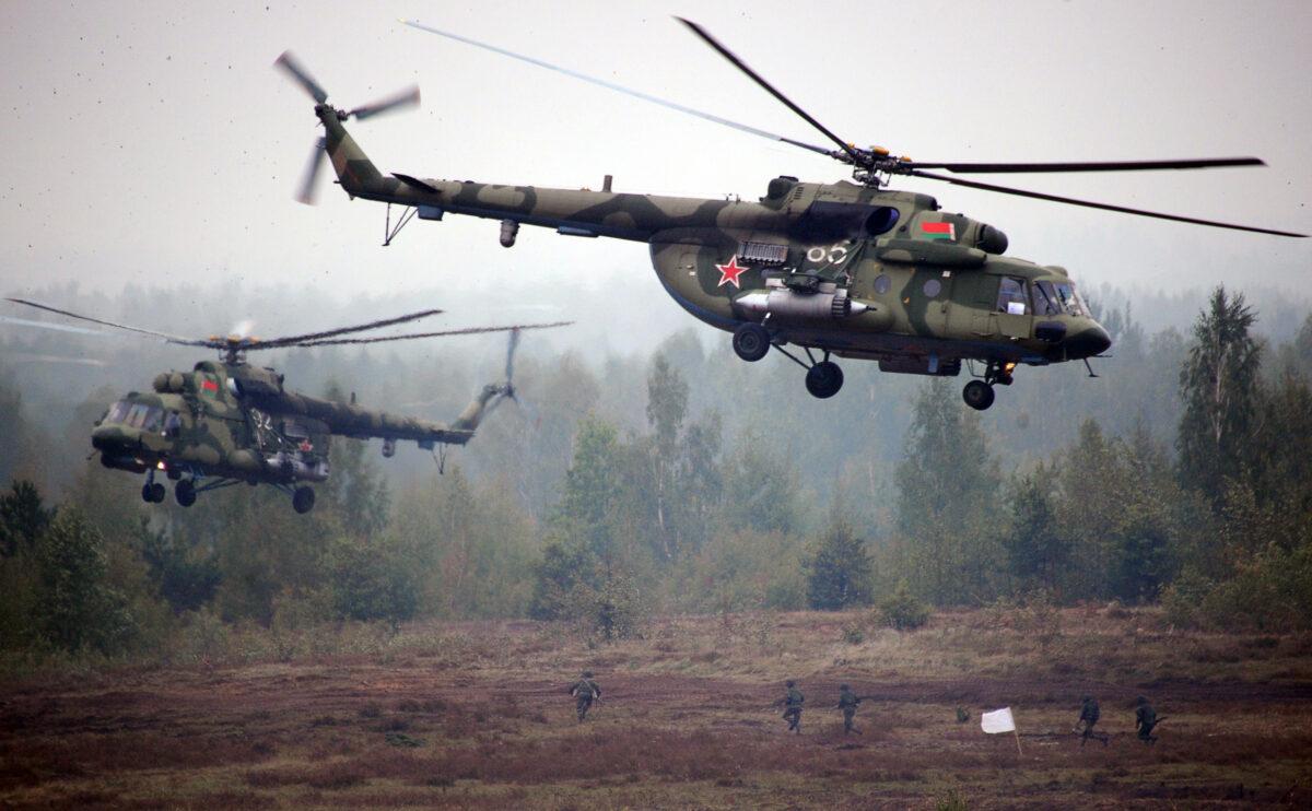 Helicopters fly above servicemen running to positions during the joint Russian-Belarusian military exercises Zapad-2017 (West-2017) at a training ground near the town of Borisov on Sept. 20, 2017. (Sergei Gapon/AFP via Getty Images)