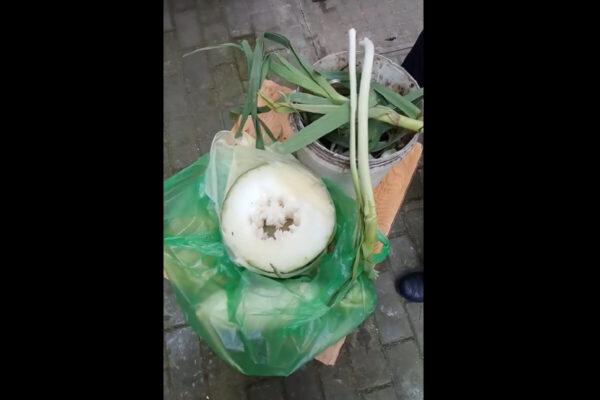 This undated photo shows an 80-year-old Wuhan resident receiving limited food supplies during the lockdown in Wuhan, China. (Courtesy of Zhang Zhan)