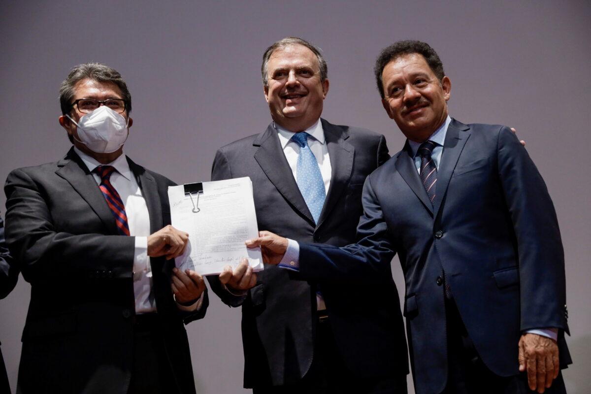 Mexican Foreign Minister Marcelo Ebrard, flanked by Senator Ricardo Monreal (L) and lawmaker Ignacio Mier (R), both of the Morena ruling party, pose for a photo during a news conference to announce that Mexico sued several gun makers in a U.S. federal court, in Mexico City, Mexico on Aug. 4, 2021. (Luis Cortes/Reuters)