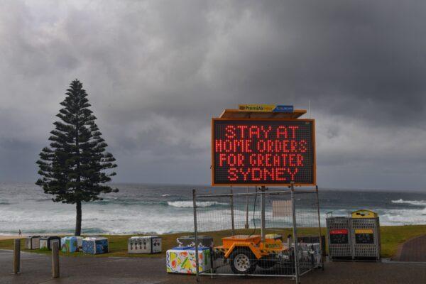 A COVID-19 warning sign is seen at Bondi Beach in Sydney, Australia, on July 10, 2021. (AAP Image/Mick Tsikas)
