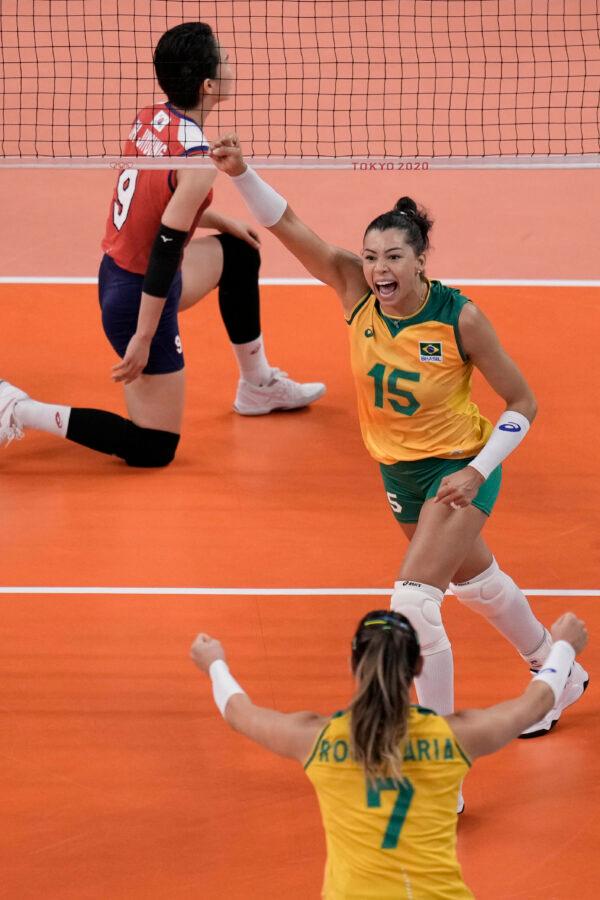 Brazil players celebrate winning a point during the women's volleyball semifinal match between Brazil and South Korea at the 2020 Summer Olympics in Tokyo, Japan, on Aug. 6, 2021. (Manu Fernandez/AP Photo)