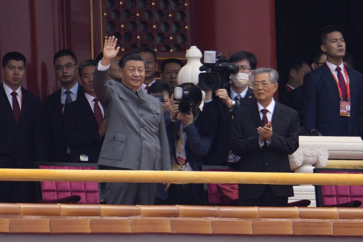 Chinese leader Xi Jinping waves during a ceremony to mark the 100th anniversary of the founding of the Chinese Communist Party at Tiananmen Gate in Beijing on July 1, 2021. (Ng Han Guan/AP Photo)
