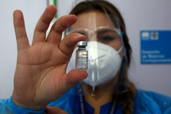 A healthcare worker shows a dose of the Sinovac vaccine during the first day of the mass vaccination campaign in Santiago, Chile, on Feb. 3, 2021. (Marcelo Hernandez/Getty Images)