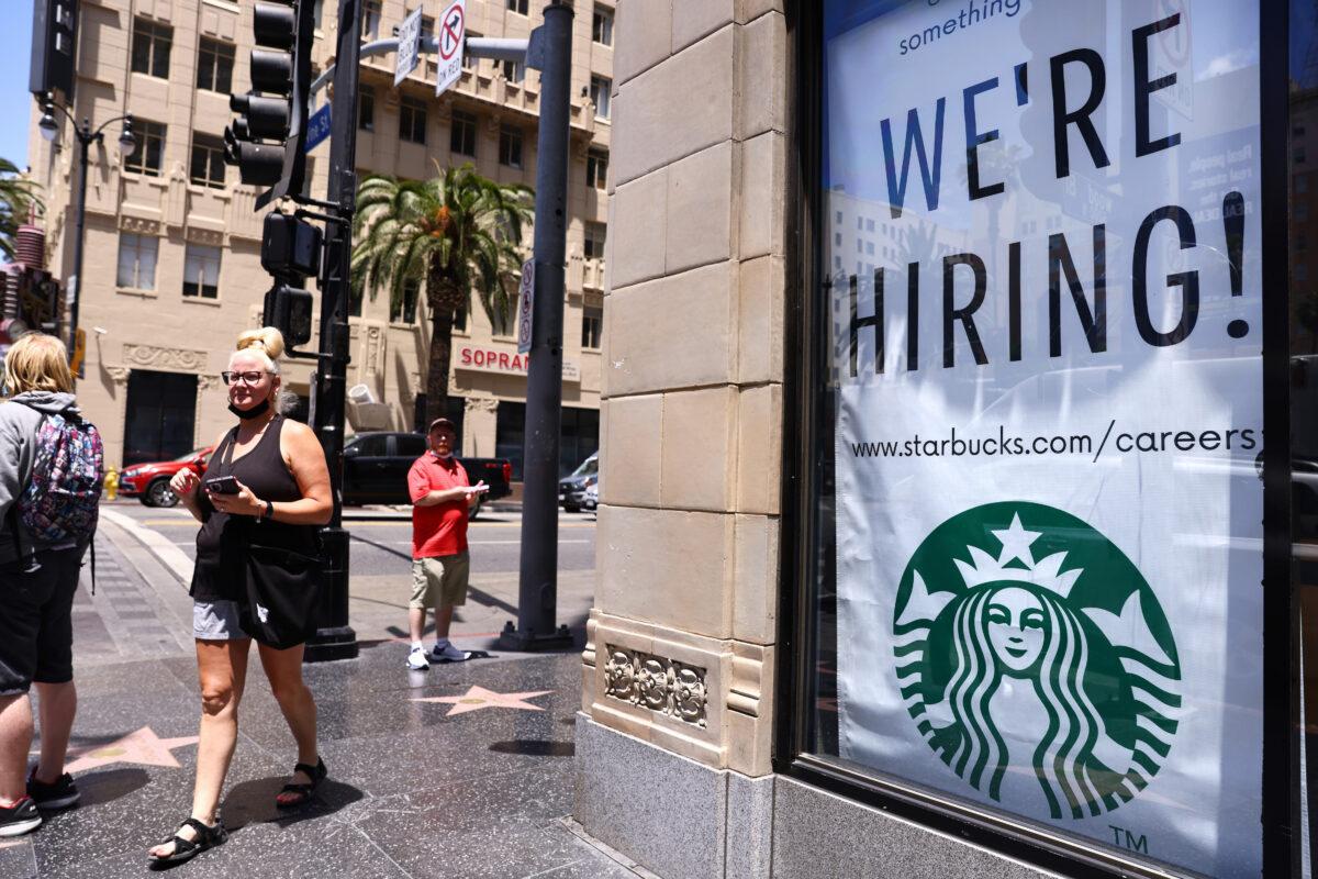 A 'We're Hiring!' sign is displayed at a Starbucks on Hollywood Boulevard in Los Angeles, Calif., on June 23, 2021. (Mario Tama/Getty Images)