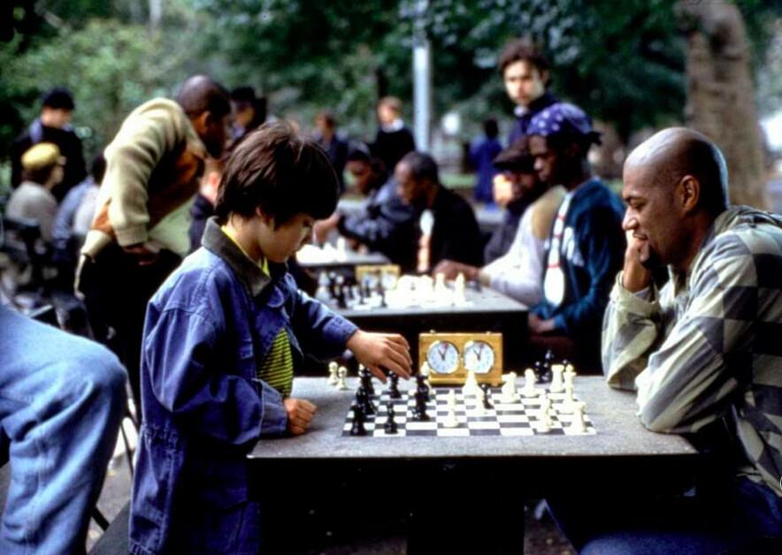 Josh Waitzkin (Max Pomeranc, L) and Vinnie, his first chess teacher (Laurence Fishburne), in “Searching for Bobby Fischer.” (Paramount Pictures)