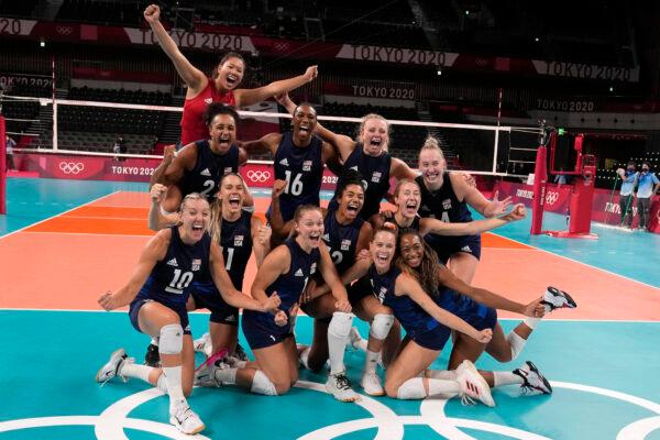 U.S. players celebrate winning the women's volleyball semifinal match between Serbia and the United States at the 2020 Summer Olympics, in Tokyo, Japan, on Aug. 6, 2021. (Frank Augstein/AP Photo)