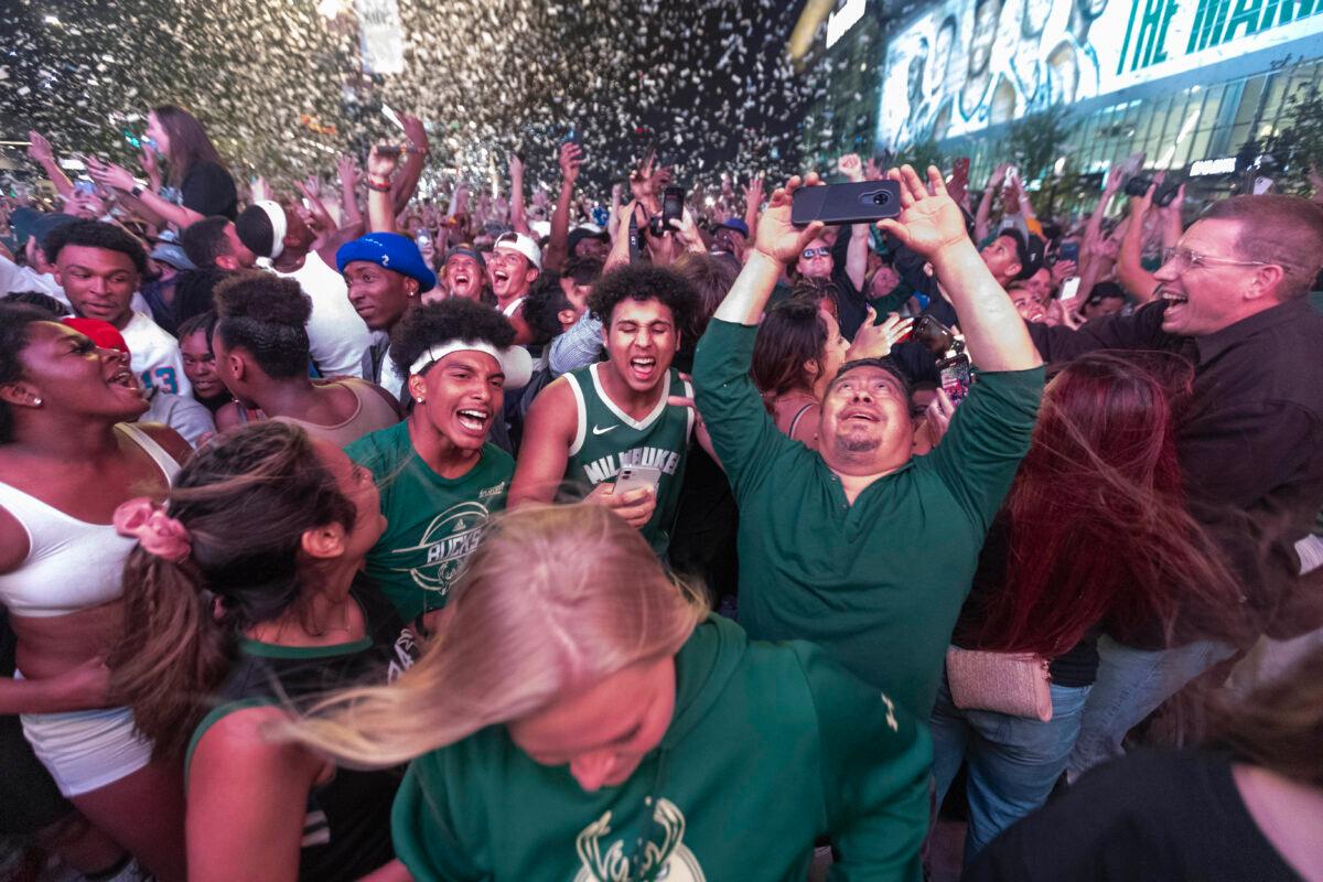 Milwaukee Bucks fans celebrate their first NBA title in 50 years after Game 6 of the NBA Finals in the Deer District outside Fiserv Forum in Milwaukee, Wis., on July 20, 2021. (Mark Hoffman/Milwaukee Journal Sentinel-USA Today Sports)