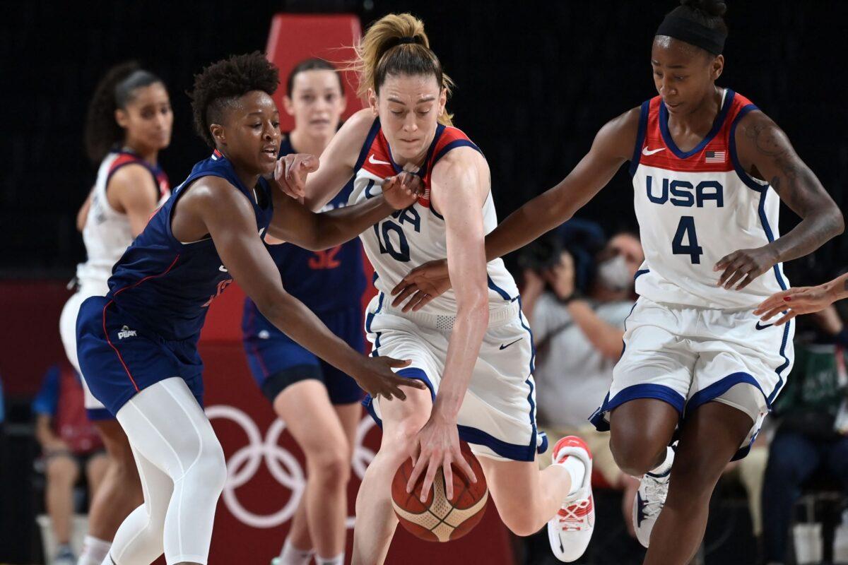 USA's Breanna Stewart (C) dribbles the ball past Serbia's Yvonne Anderson (L) and USA's Jewell Loyd in the women's semi-final basketball match between USA and Serbia during the Tokyo 2020 Olympic Games at the Saitama Super Arena in Saitama, Japan, on Aug. 6, 2021. (Aris Messinis/AFP via Getty Images)
