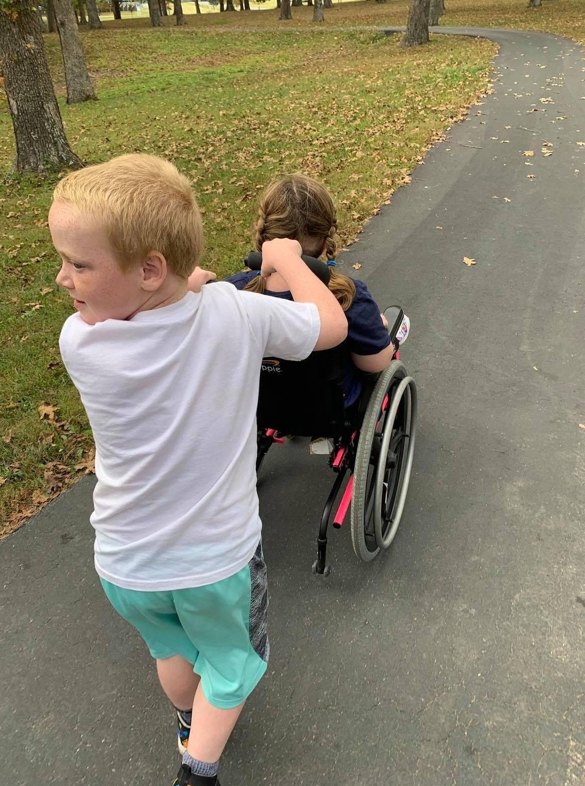 Jesse with Claire in a wheelchair. (Courtesy of <a href="https://www.facebook.com/shauna.starr.564">Shauna Starr</a>)