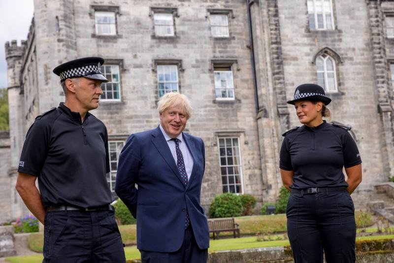 Britain's Prime Minister Boris Johnson meets officers during a visit to the Scottish Police College at Tulliallan near Kincardine, Scotland, on August 4, 2021. (James Glossop/Pool via Reuters)