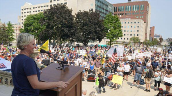 Tammy Clark of "Stand Up Michigan" urges protesters to "Get radical!" with nonviolent civil disobedience at an anti-government-mandate rally on the State Capitol grounds in Lansing, Mich., on Aug. 6, 2021. (Steven Kovac/Epoch Times)