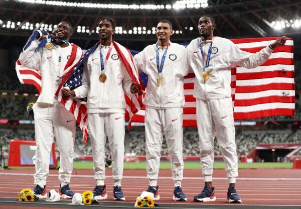 Gold medal winners Bryce Deadmon, Michael Cherry, Michael Norman, and Rai Benjamin of Team USA celebrate with their medals after the Men's 4 x 400m Relay on day fifteen of the Tokyo 2020 Olympic Games at Olympic Stadium in Tokyo, Japan, on Aug. 7, 2021. (Ryan Pierse/Getty Images)