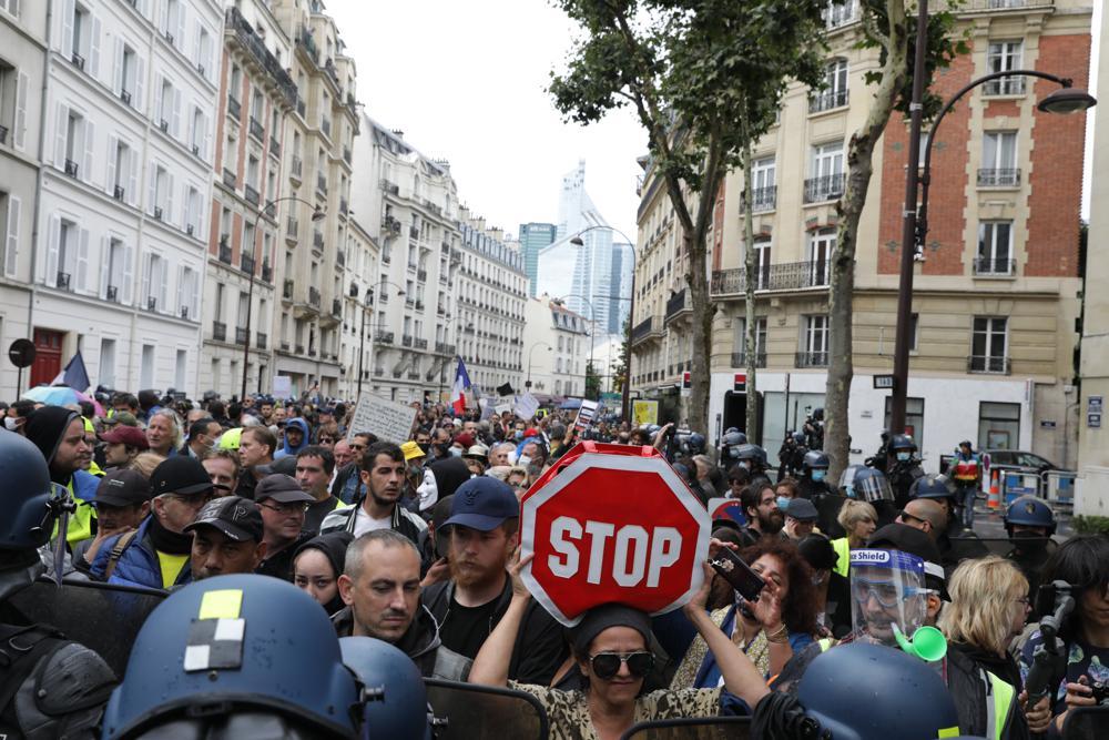 Protesters gather to protest against France's vaccine passport system during a demonstration in Paris, on Aug. 7, 2021. (AP Photo / Adrienne Surprenant)
