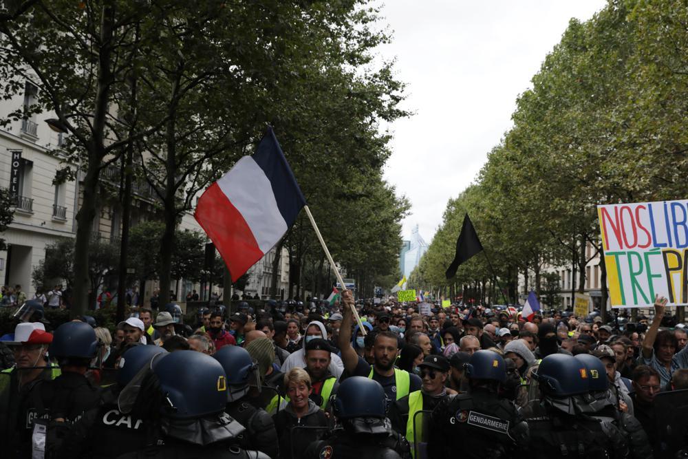 Protesters gather to protest against France's vaccine passport system during a demonstration in Paris, on Aug. 7, 2021. (AP Photo / Adrienne Surprenant)