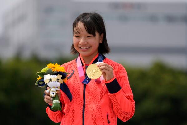 Gold medal winner Momiji Nishiya of Japan holds her medal after winning the women's street skateboarding finals at the 2020 Summer Olympics in Tokyo, Japan, on July 26, 2021. (Ben Curtis/AP Photo)