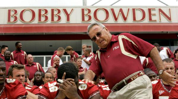 Florida State head football coach Bobby Bowden (R) squeezes into his seat for a team photo during media day activities in Tallahassee, Fla., on Aug. 12, 2007. (Phil Coale/AP Photo)