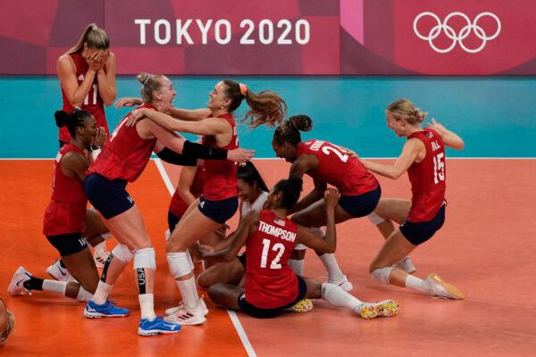 Players from the United States react after defeating Brazil to win the gold medal in women's volleyball at the 2020 Summer Olympics, in Tokyo, Japan, on Aug. 8, 2021. (Frank Augstein/AP Photo)