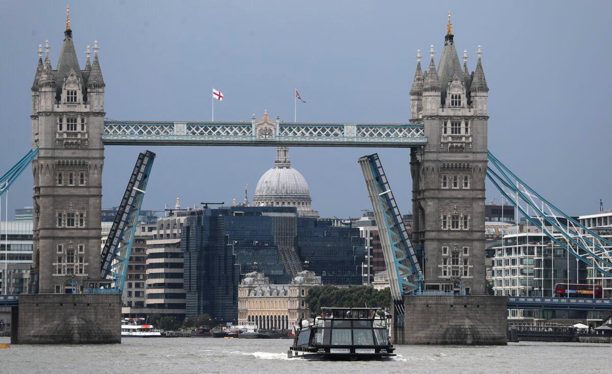A boat sails down the River Thames in London on Aug. 9, 2021, in front of Tower Bridge that is stuck in the fully open position due to a technical fault. (Tony Hicks/AP Photo)