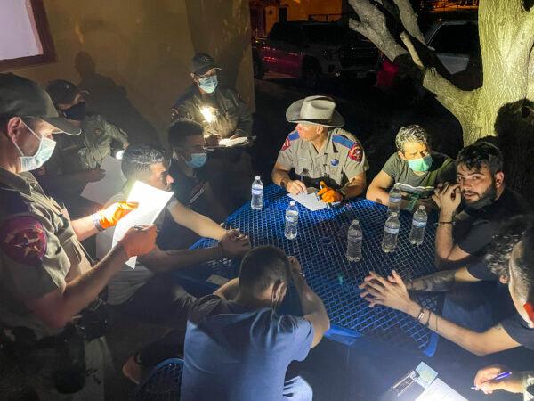Texas State Troopers complete paperwork after arresting illegal immigrants from Cuba for criminal trespass on a local ranch, at the Kinney County Sheriff's Office in Brackettville, Texas, on Aug. 8, 2021. (Charlotte Cuthbertson/The Epoch Times)