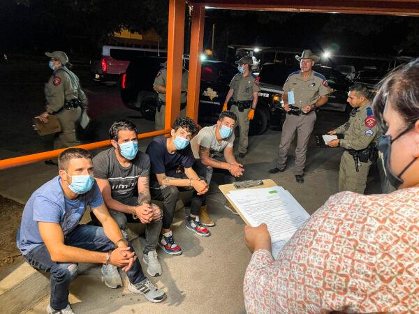 Kinney County Justice of the Peace Narce Villarreal (R) magistrates a group of illegal immigrants from Cuba as they’re charged for criminal trespass on a local ranch, at the Kinney County Sheriff's Office in Brackettville, Texas, on Aug. 8, 2021. (Charlotte Cuthbertson/The Epoch Times)