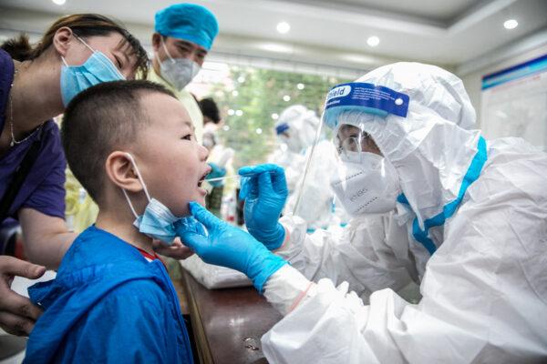 A child is tested for COVID-19 in Nantong, in eastern China's Jiangsu Province, on Aug. 8, 2021. (STR/AFP via Getty Images)