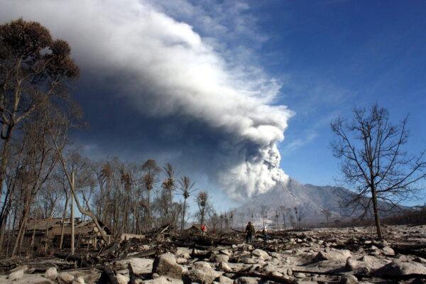 Indonesian rescue members look for victims of Merapi volcano's eruption in the village of Glagaharjo, Indonesia, in the district of Sleman on Nov. 12, 2010. (Lintang Senja/AFP via Getty Images)