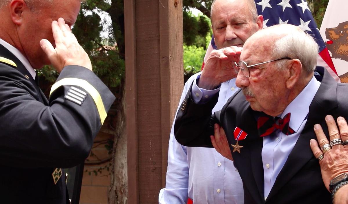 WWII veteran U.S. Army Private First Class Ubaldo Joseph Ciniero receiving his award on July 27. (Screenshot/<a href="https://www.dvidshub.net/video/808425/heroism-knows-no-age-wwii-veteran-presented-bronze-star-medal-75-years-later">Staff Sgt. Kimberly Hill/DVIDSHUB</a>)
