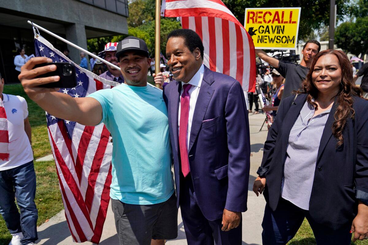 California gubernatorial candidate Larry Elder, center, poses for selfies with supporters during a campaign stop in Norwalk, Calif., on July 13, 2021. (Marcio Jose Sanchez/AP Photo)