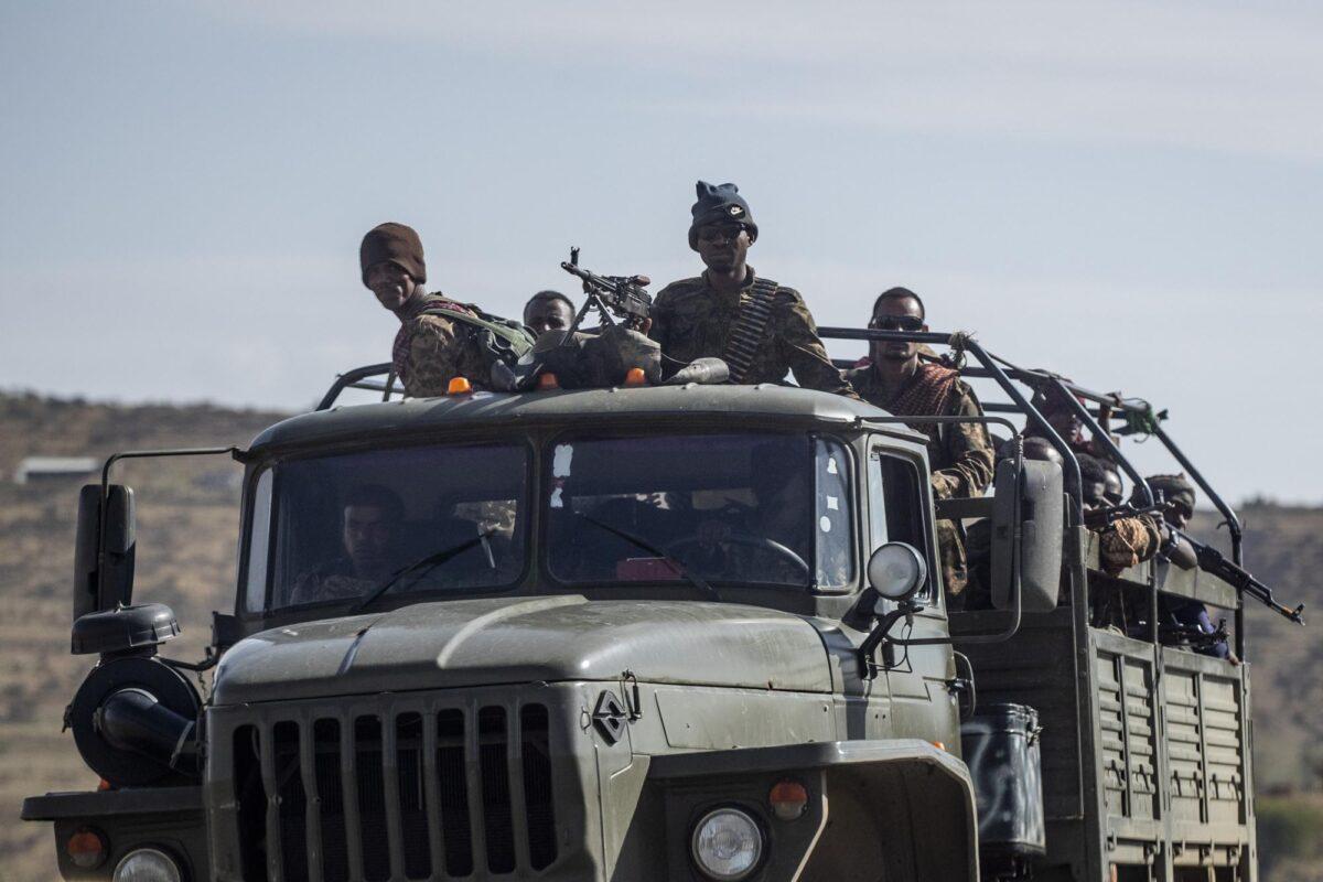 Ethiopian government soldiers ride in the back of a truck on a road near Agula, north of Mekele, in the Tigray region of northern Ethiopia on May 8, 2021. (Ben Curtis/AP Photo)