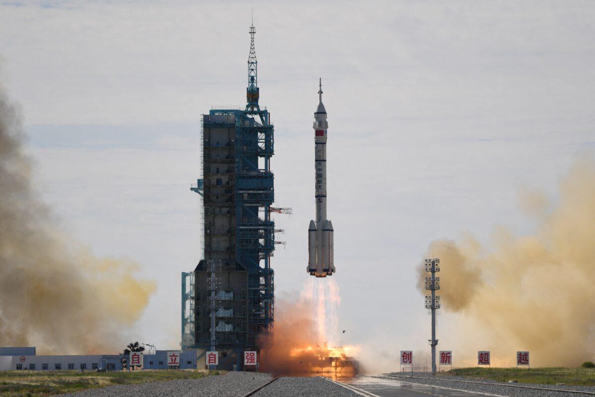 A Long March-2F carrier rocket, carrying the Shenzhou-12 spacecraft and a crew of three astronauts, lifts off from the Jiuquan Satellite Launch Centre in the Gobi desert, in northwest China on June 17, 2021, the first crewed mission to China's new space station. (Greg Baker/AFP via Getty Images)