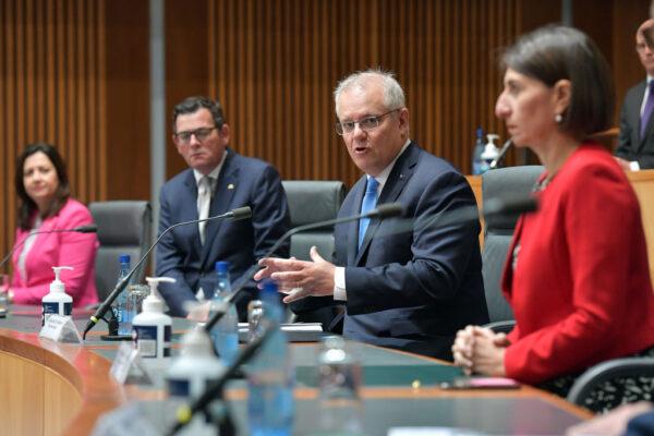 Australian Prime Minister Scott Morrison (centre), together with State Premiers Annastacia Palaszczuk (left), Daniel Andrews(left centre) and Gladys Berejiklian (right), address the media in the Main Committee Room at Parliament House, in Canberra, Australia, on Dec. 11, 2020. (Sam Mooy/Getty Images)