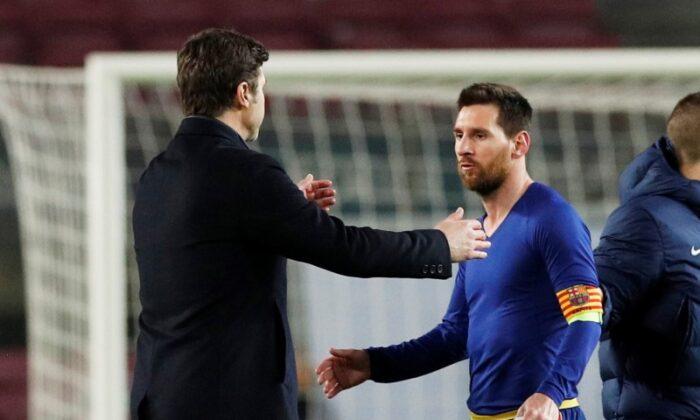 Barcelona's Lionel Messi with Paris St Germain coach Mauricio Pochettino after the match in the Champions League, in Camp Nou, Barcelona, Spain, on Feb. 16, 2021. (Albert Gea/File Photo/Reuters)