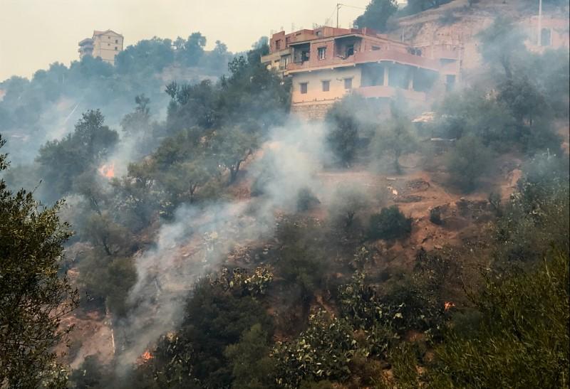 Smoke rises from a forest fire in the mountainous Tizi Ouzou province, east of the Algerian capital, Algiers on Aug. 10, 2021. (Abdelaziz Boumzar/Reuters)